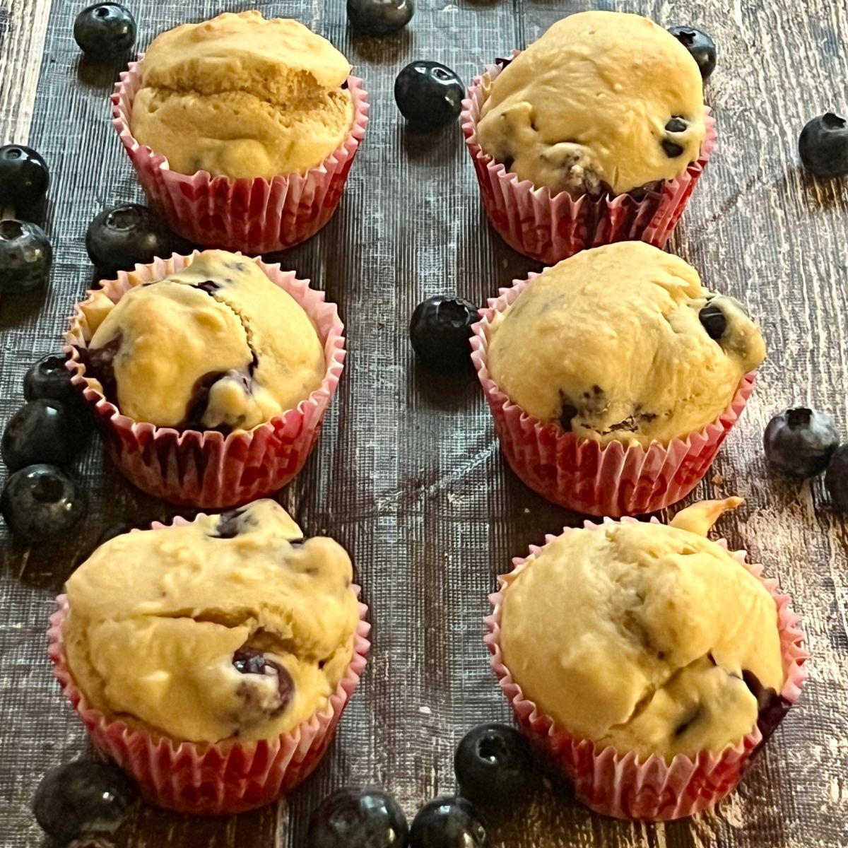 6 WW Banana Blueberry Muffins on a table with Blueberries