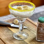 WW Banana Protein Pudding in a glass on a wooden cutting board