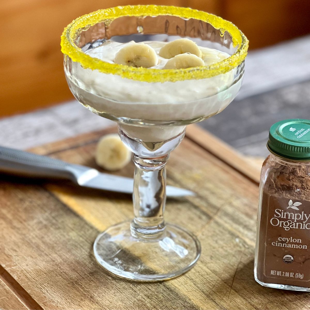WW Banana Protein Pudding in a glass on a wooden cutting board