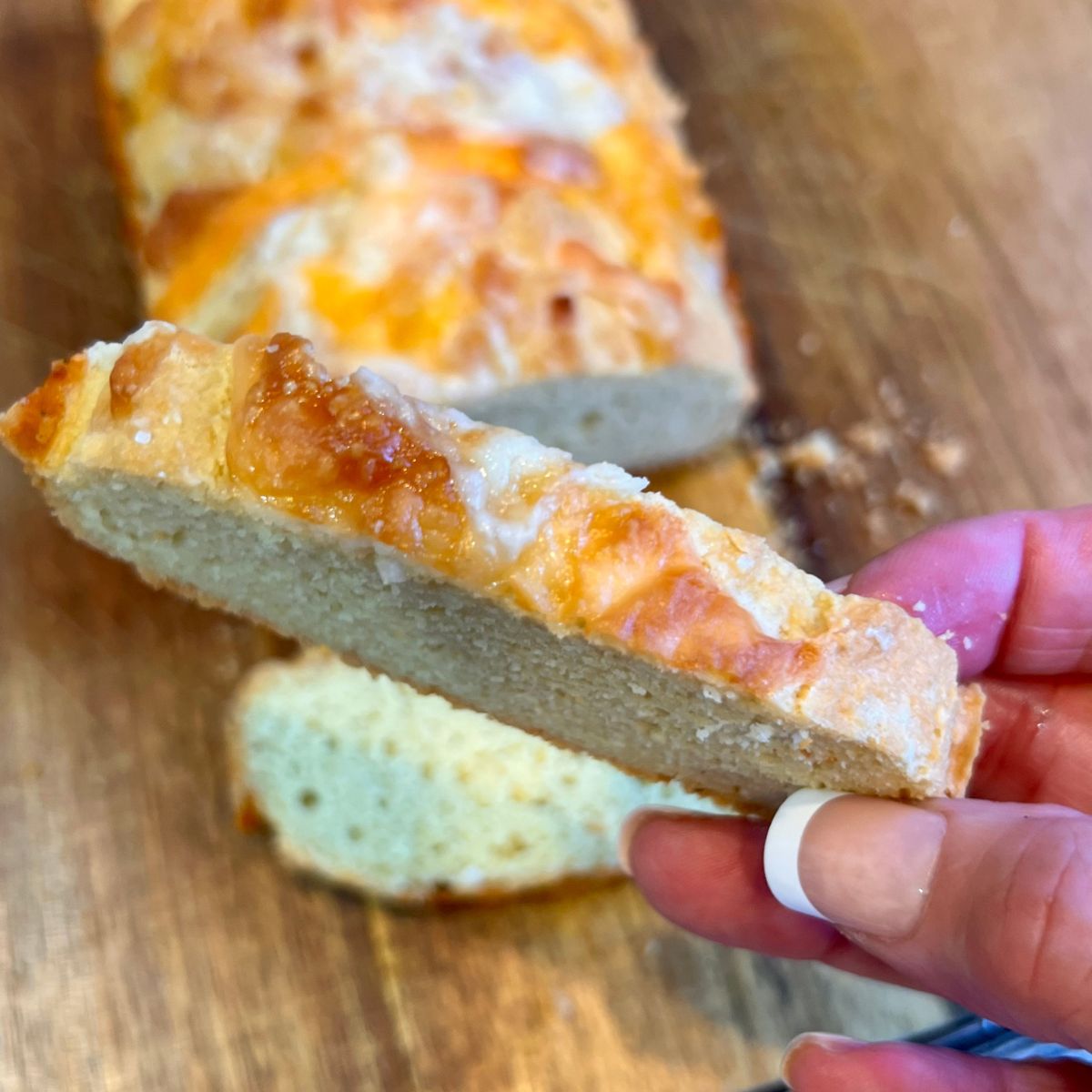 a hand holding a slice of 3 ingredient keto bread