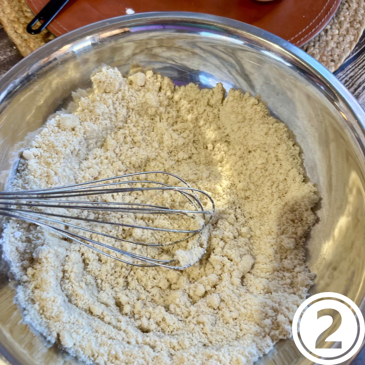 Almond flour with a whisk in a bowl