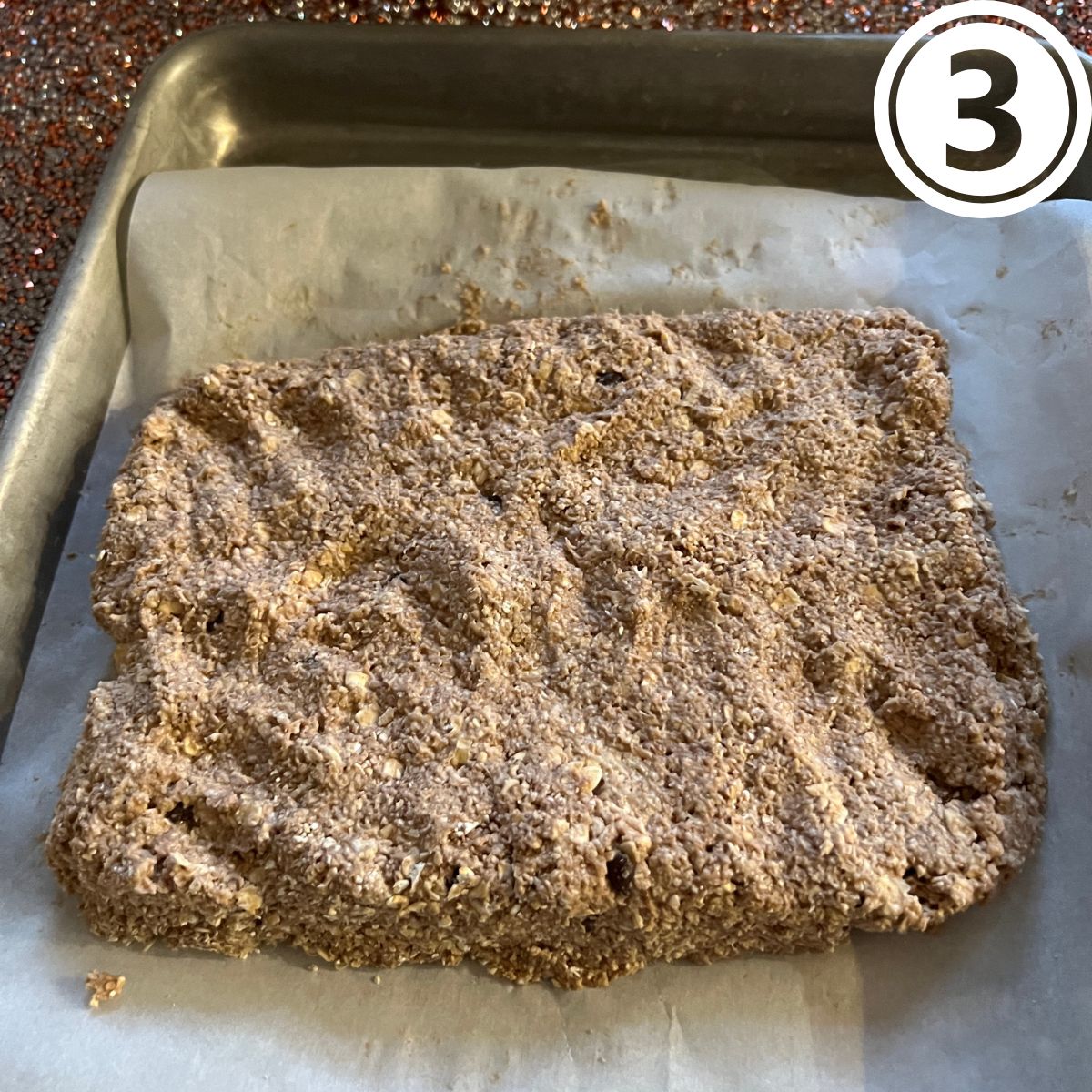 Oatmeal breakfast bar square on a sheet of parchment paper