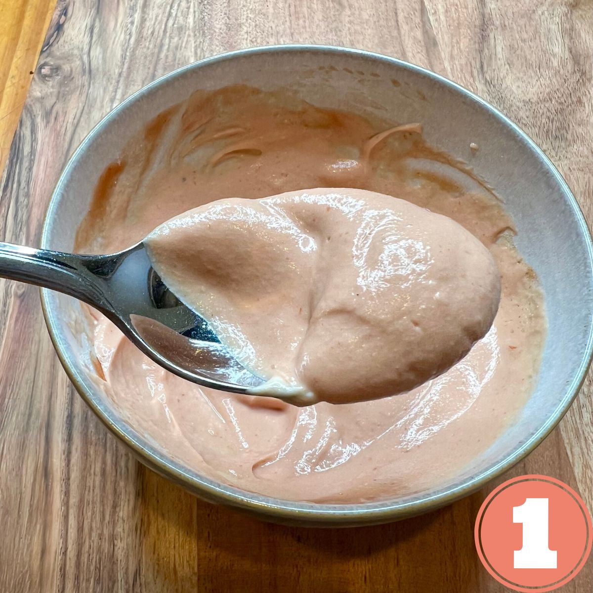 A bowl with Weight Watcher's Big Mac Sauce with a spoonful of sauce being held above the bowl