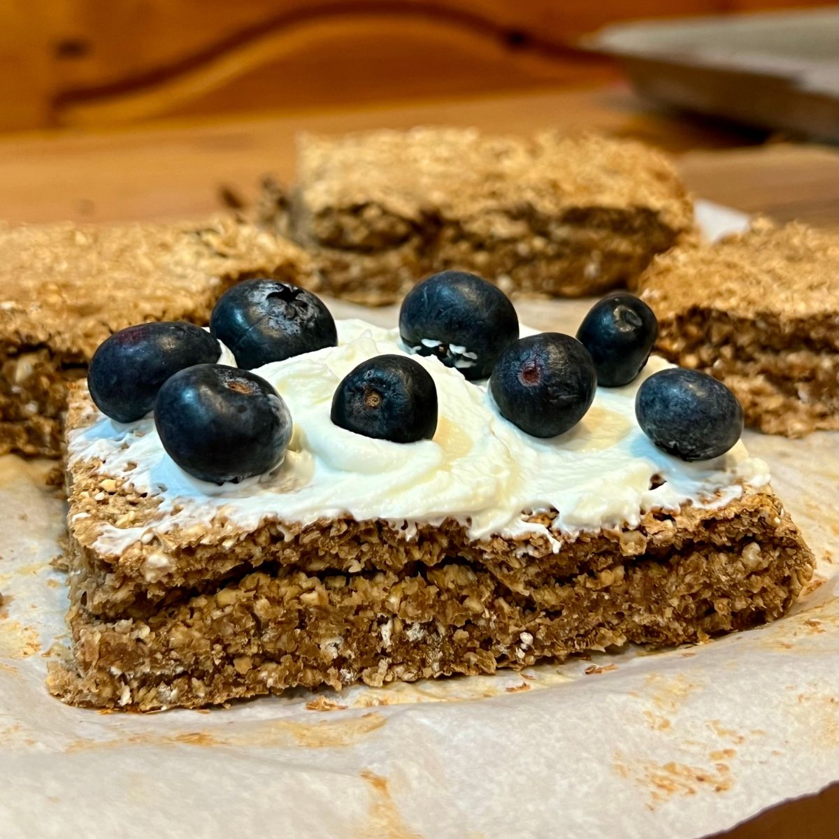 A WW Oatmeal Breakfast Bar covered with yogurt and blueberries