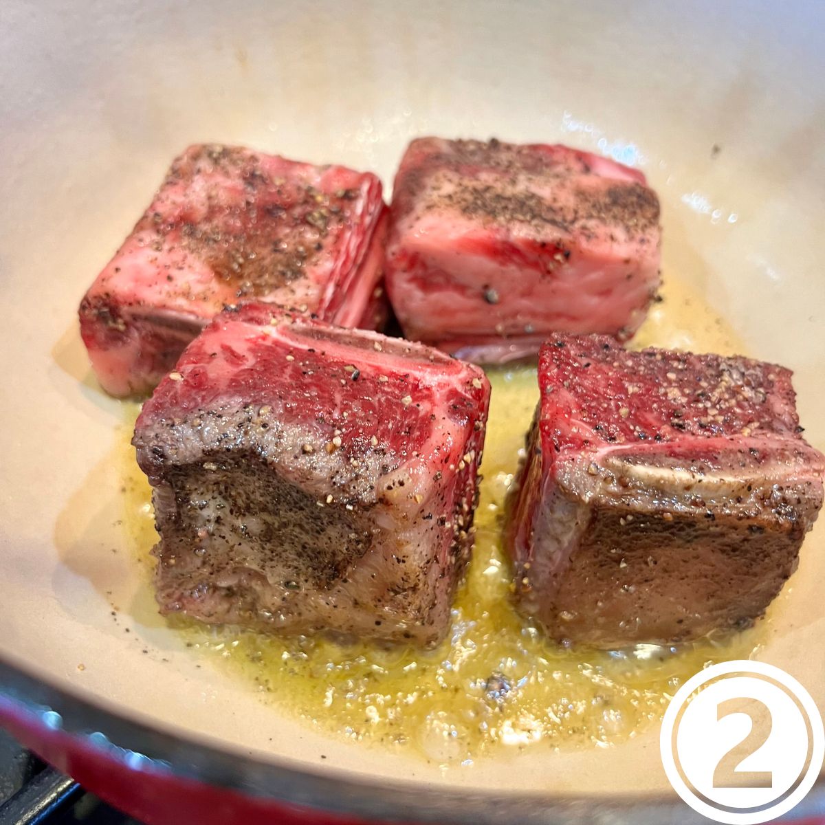 Short ribs braising in a Dutch oven