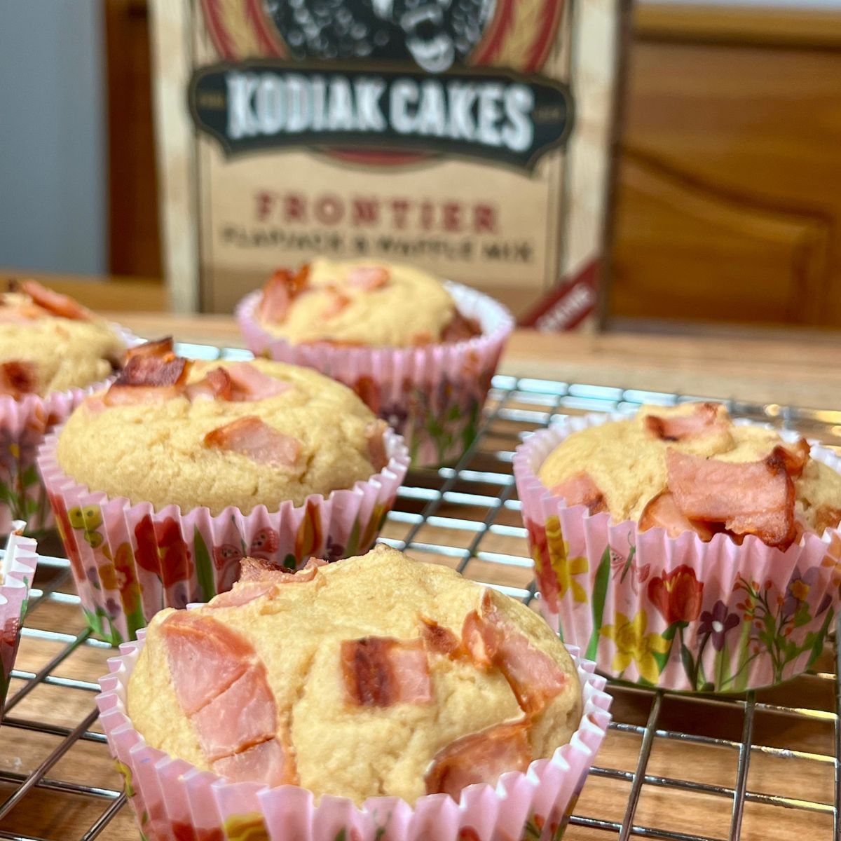 Canadian bacon pancake muffins with a box of Kodiak Cakes pancake mix on a table