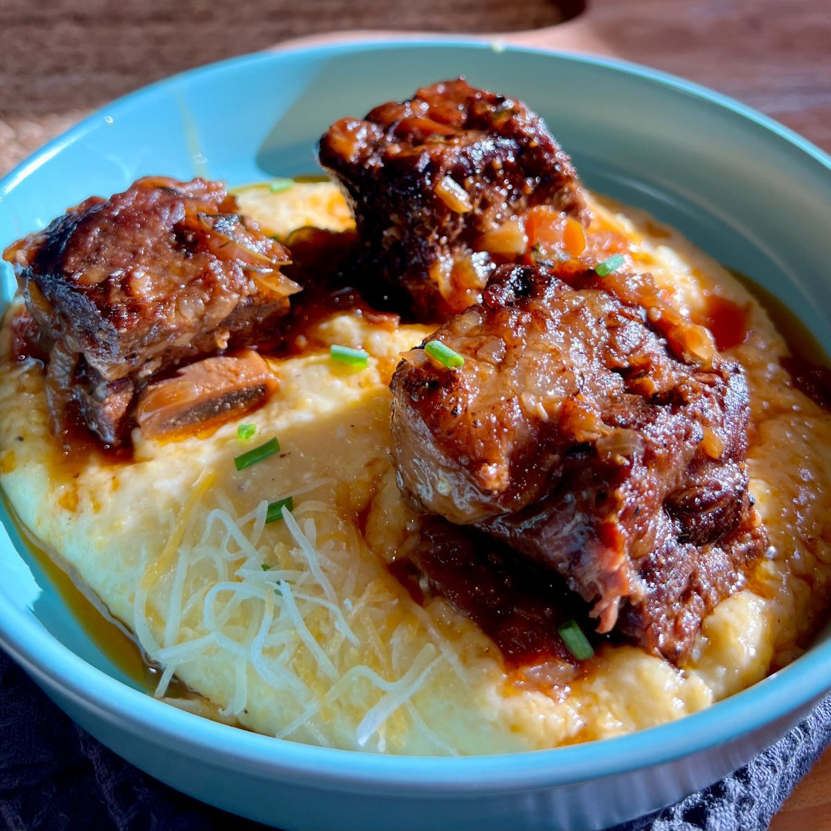 Guinness beer braised beef short ribs in a bowl over WW cheesy grits