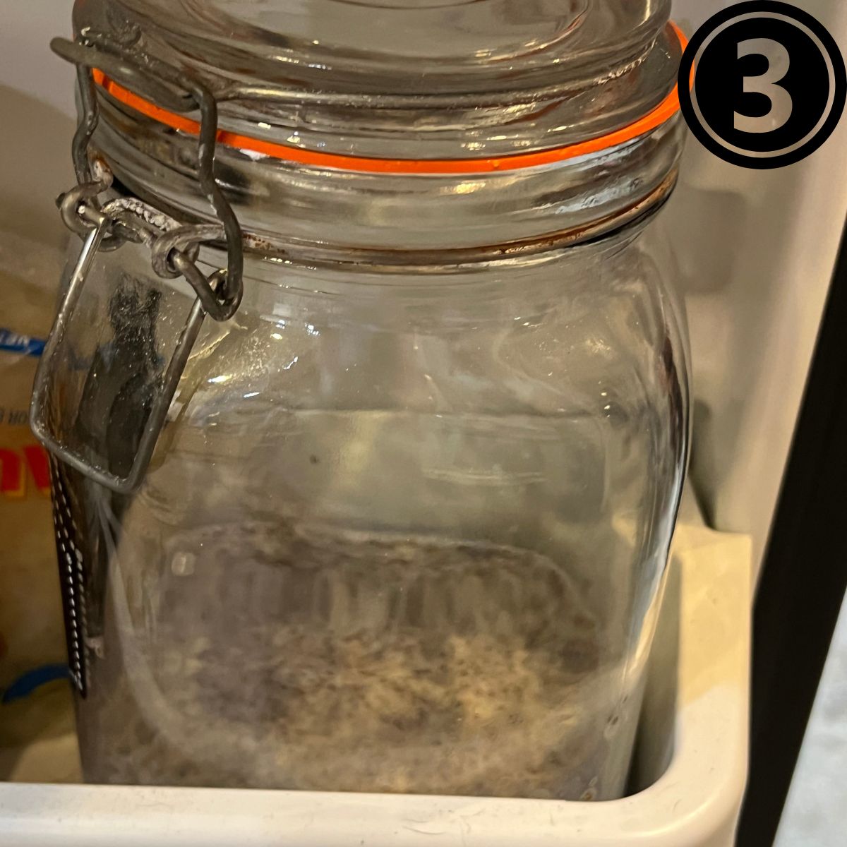 A mason jar filled with vanilla chia seed pudding in a refrigerator