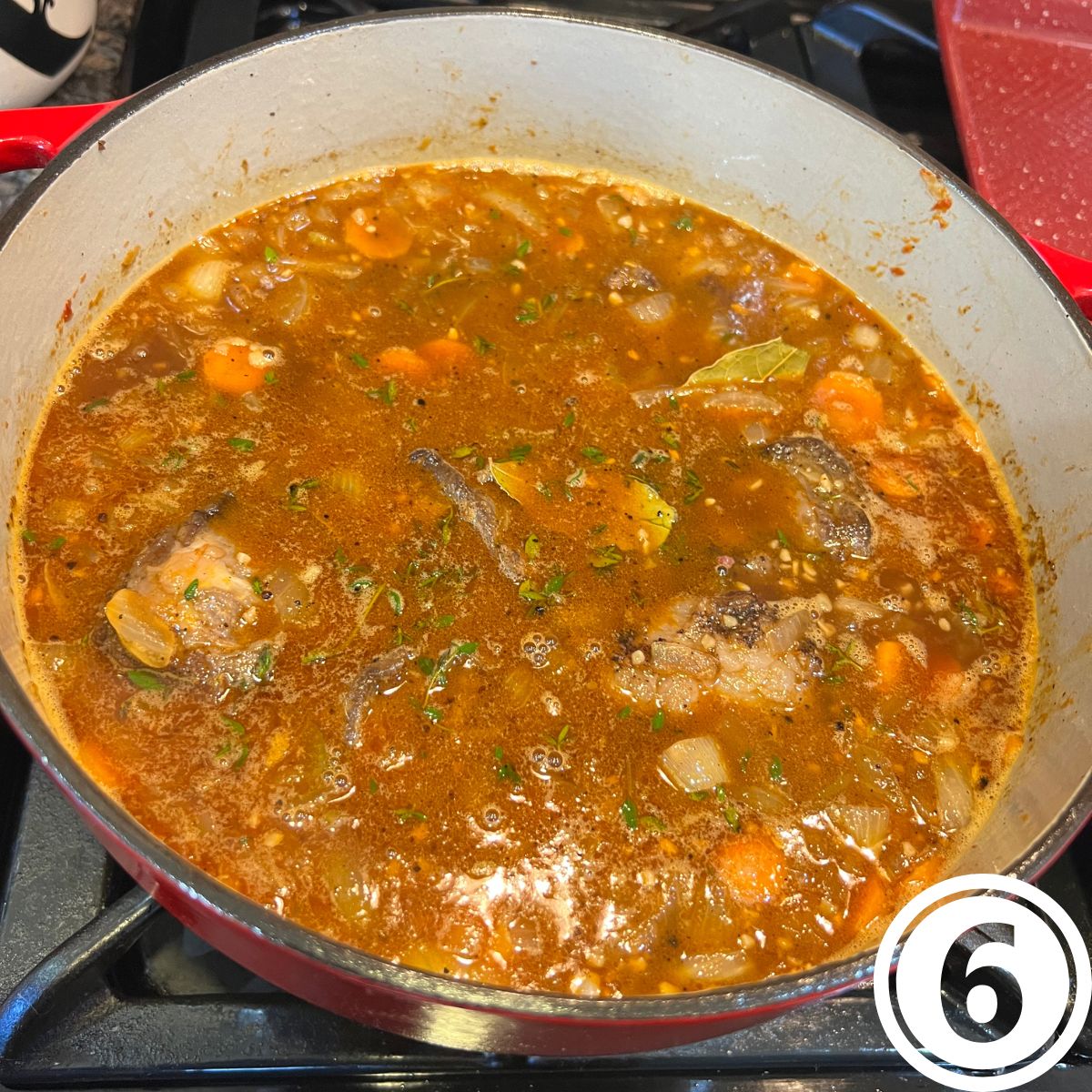 A dutch oven with simmering beef short ribs