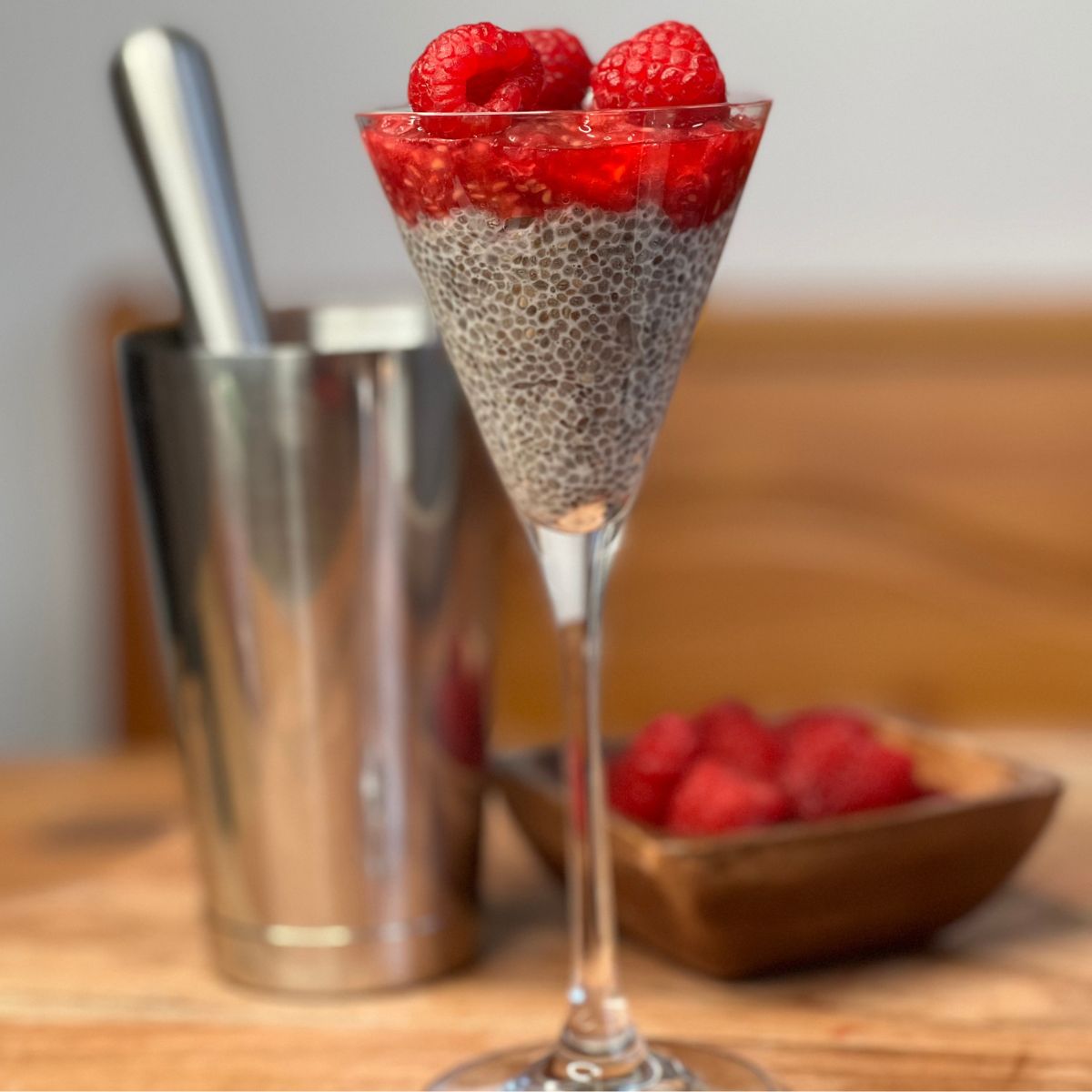 Vanilla Chia seed pudding in a glass with raspberries on top