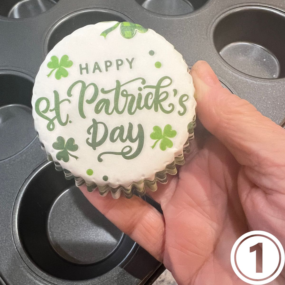 A hand holding a St Patrick's Day Muffin Paper Liner