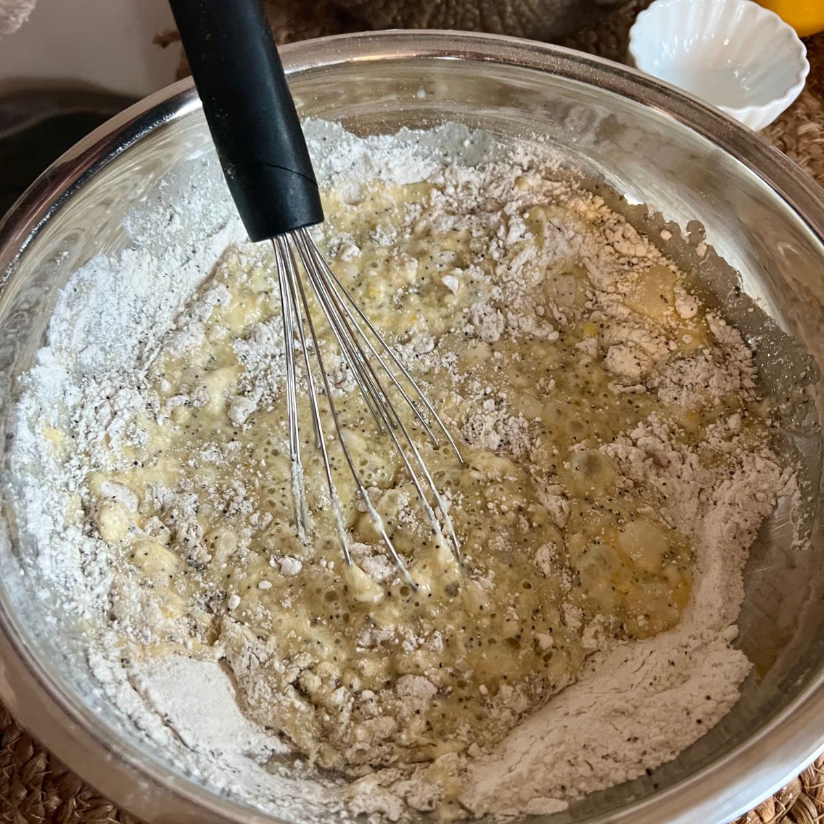 Lemon poppyseed muffin batter in a bowl