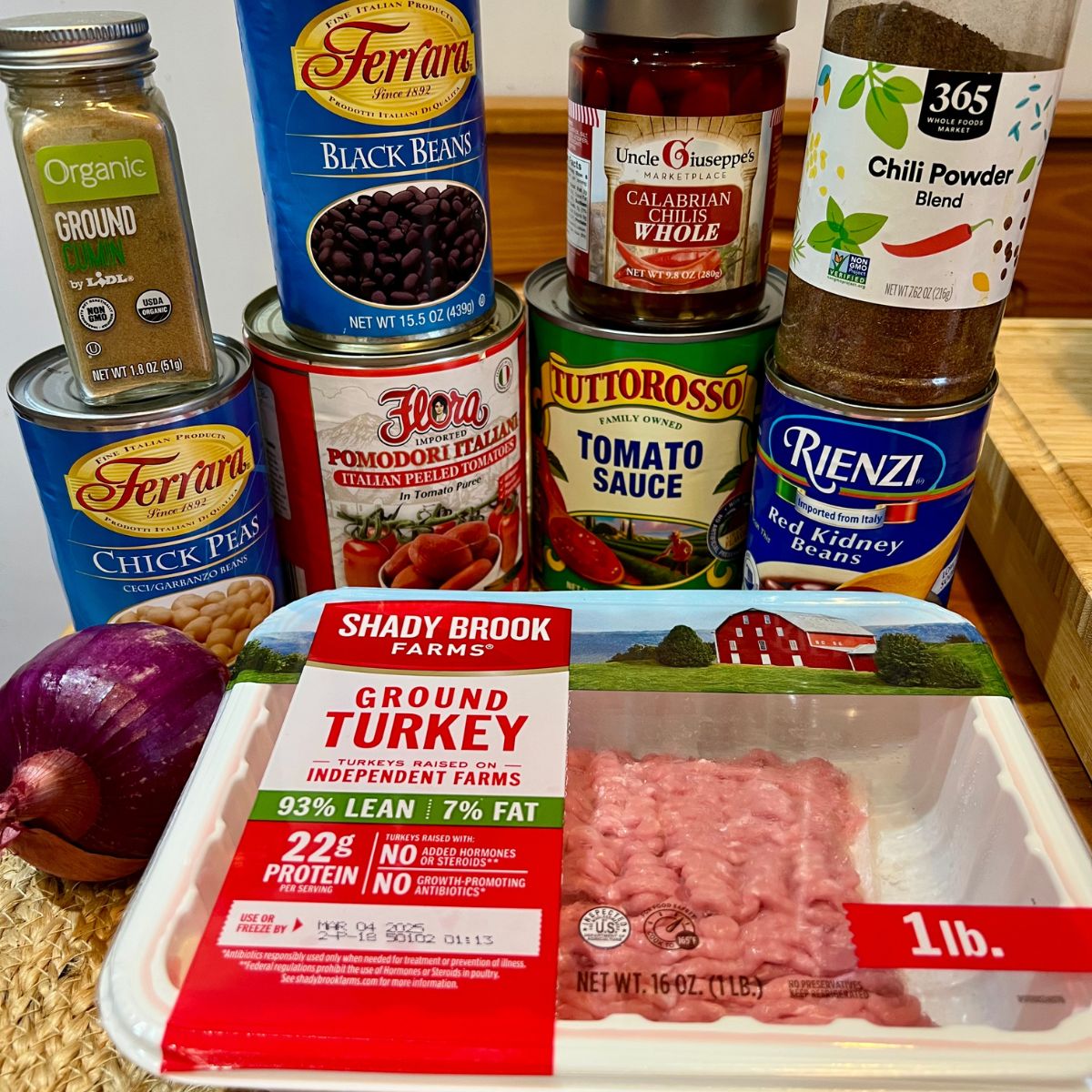 A package of ground turkey, canned beans, canned tomatoes, chili powder and cumin