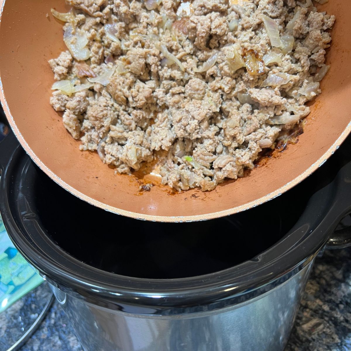 Turkey chop meat being poured into a crockpot