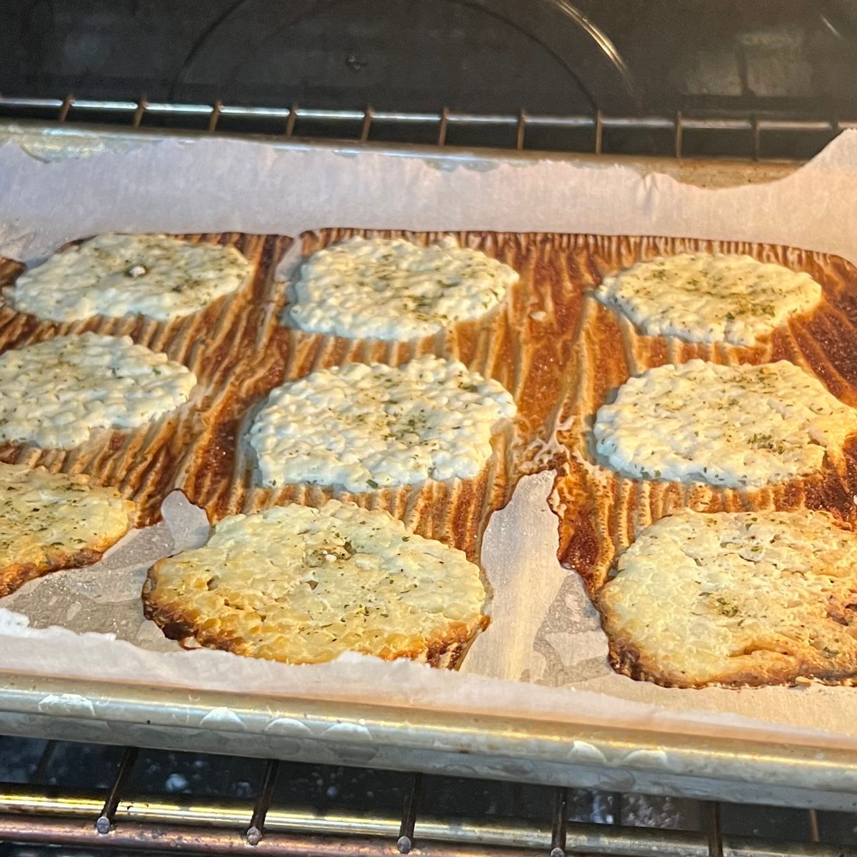 Crispy cottage cheese chips on a sheet pan in the oven