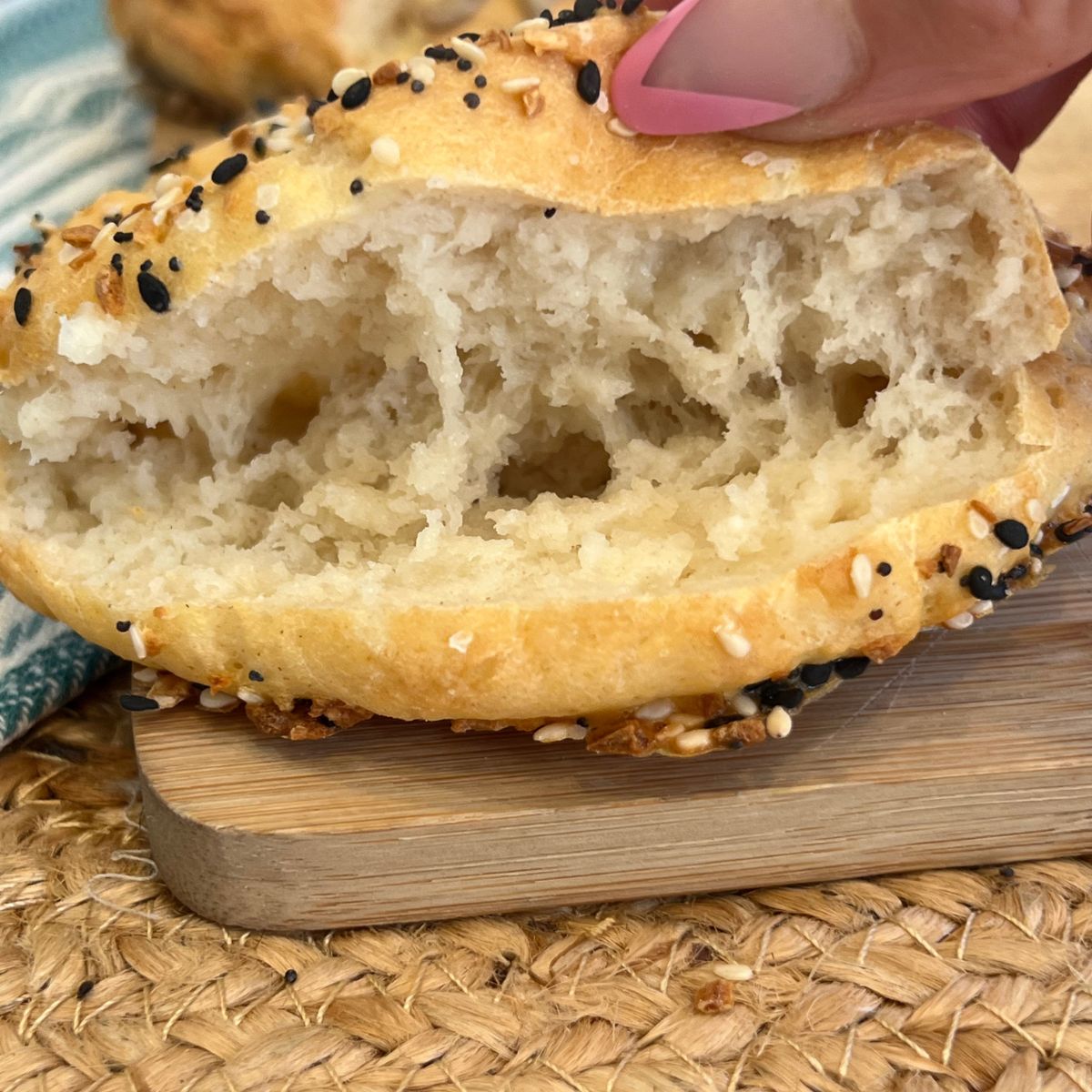 A sliced high protein cottage cheese bagel with everything seasoning