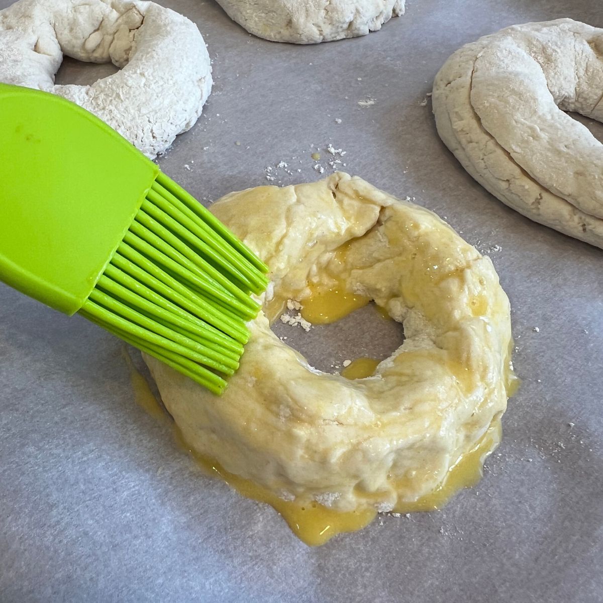 Brushing bagel dough with egg wash
