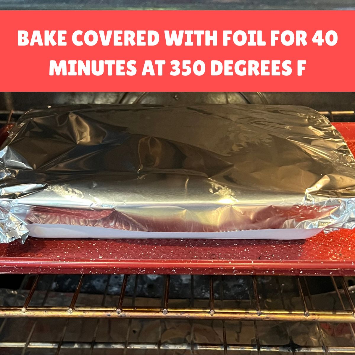 Foil covered lasagna dish baking in the oven