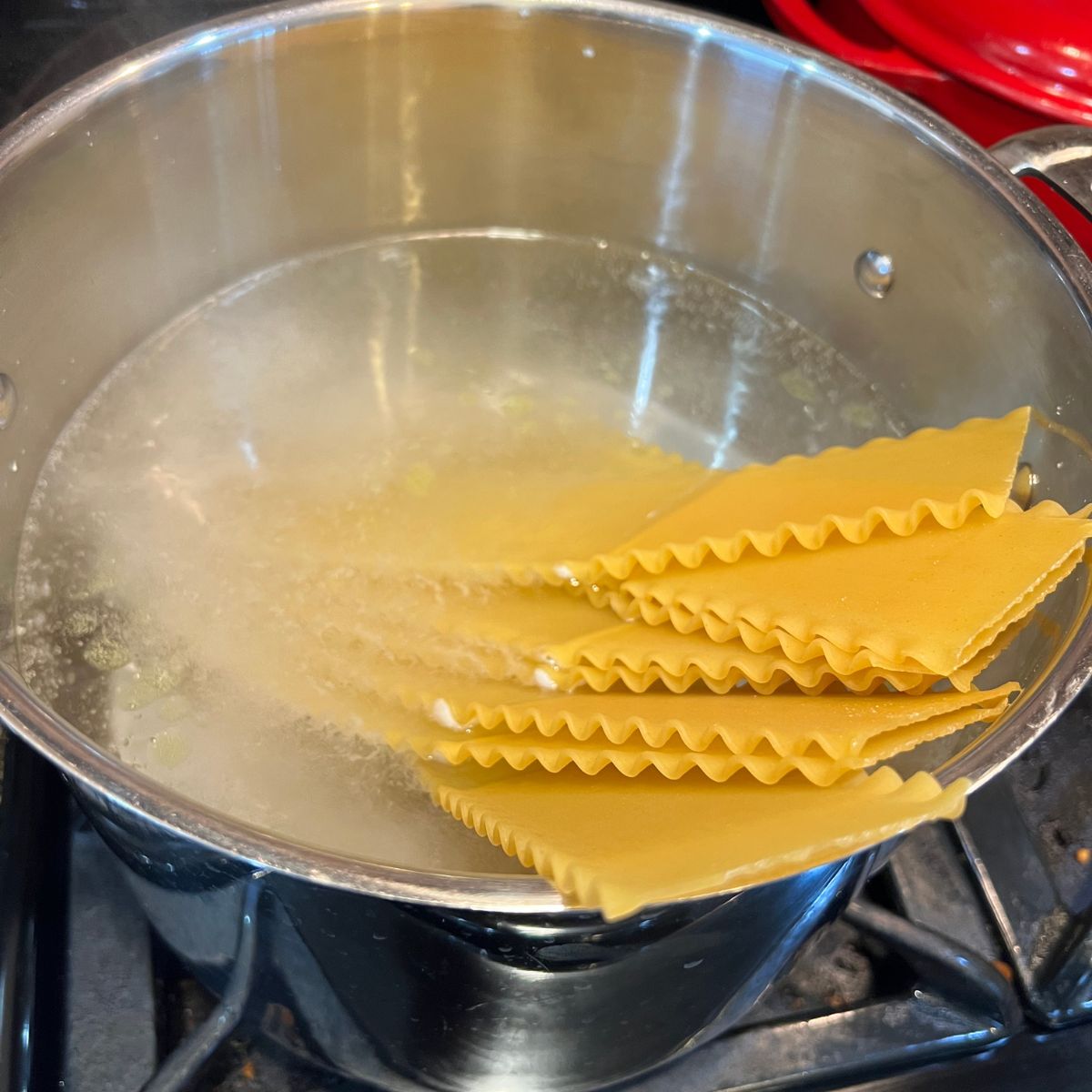 Lasagna noodles boiling in a pot of water