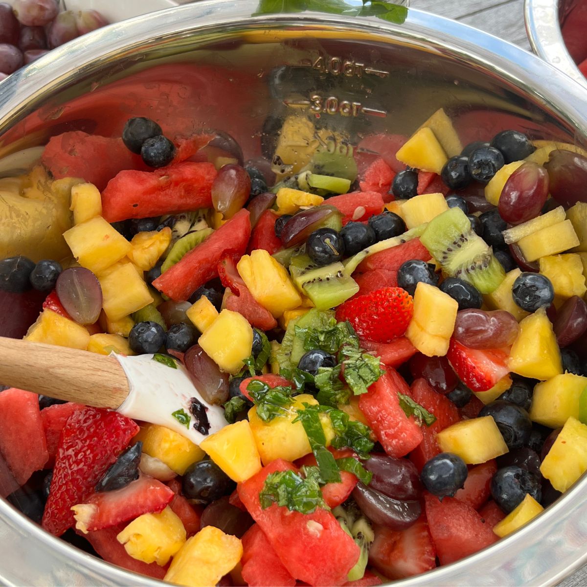 Summer fruit salad with honey lime dressing in a bowl