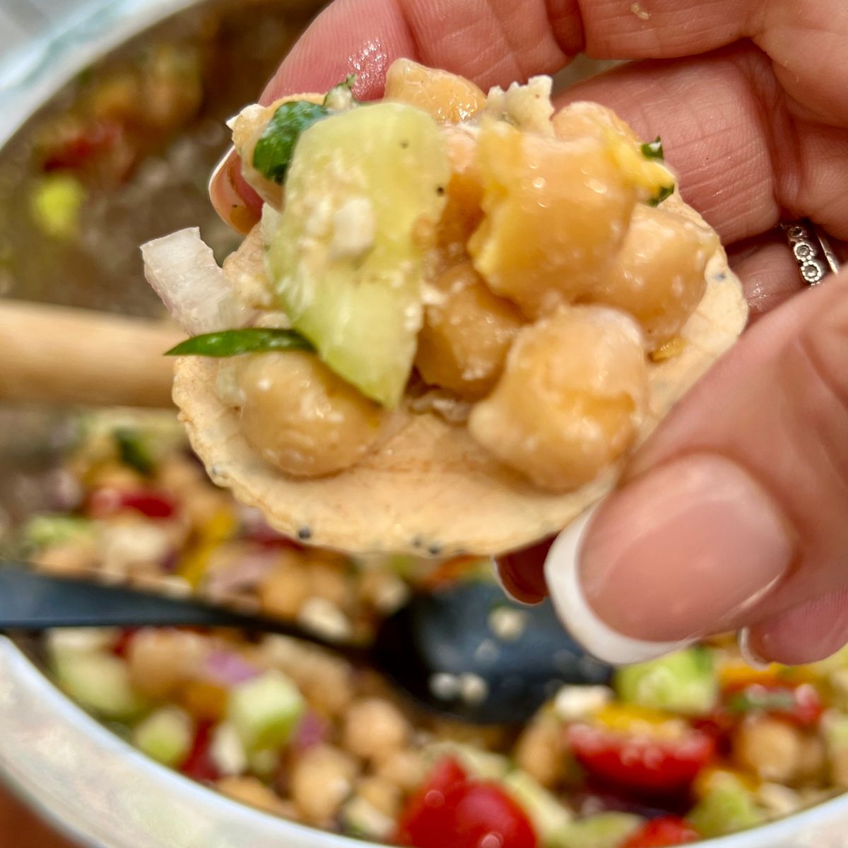 No-Bake Summer Chick Pea Salad with Lemon Feta Dressing on a cracker