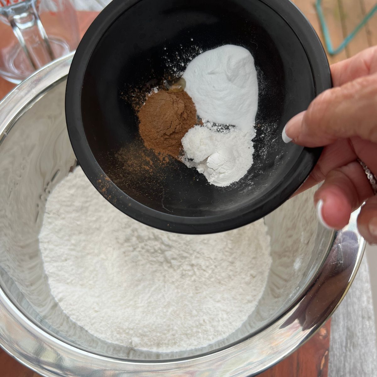 Cinnamon, baking soda and powder in a bowl for homemade banana chocolate chip zucchini muffins