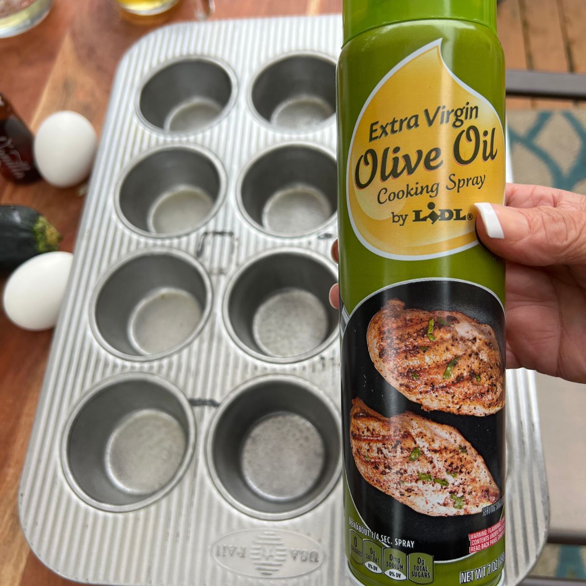 Olive oil spray and a muffin tin for baking banana zucchini muffins