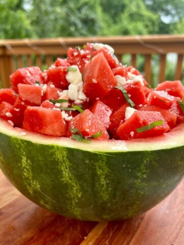 Watermelon feta mint salad in a watermelon bowl on a table