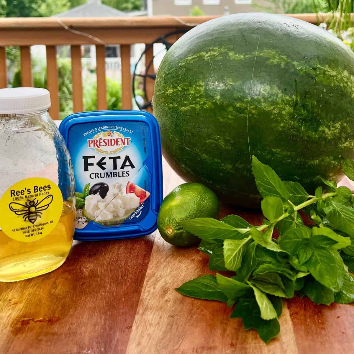 Watermelon mint feta salad ingredients on a table - watermelon honey mint and feta cheese