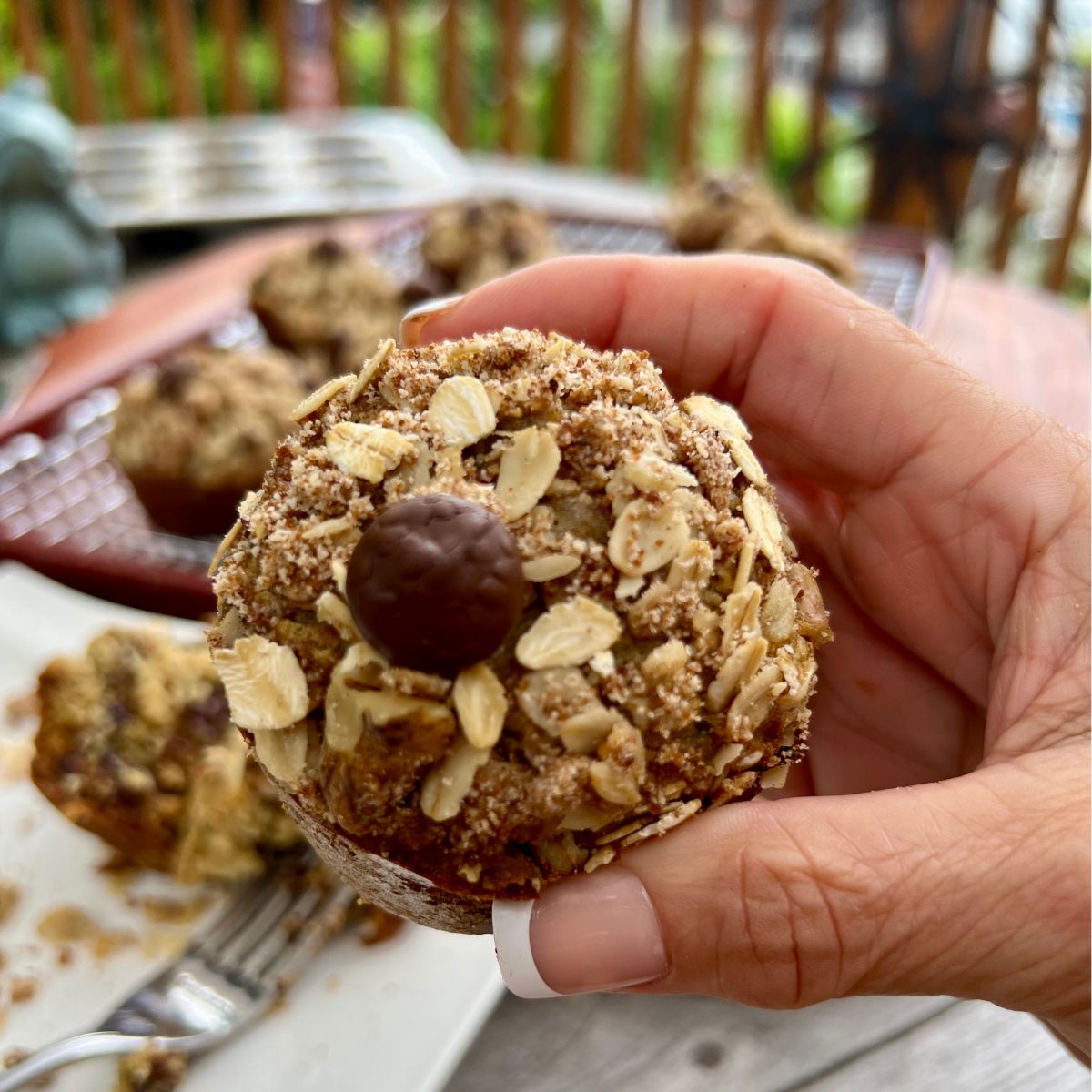 Chocolate Chip banana zucchini crumbl muffin in a hand