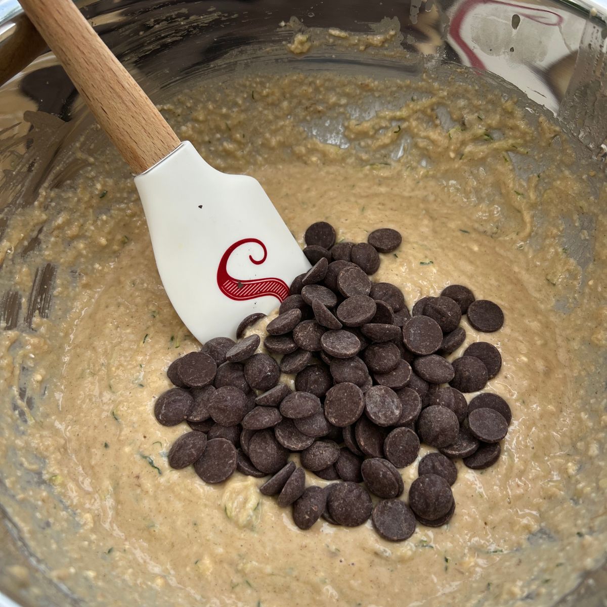 dark chocolate chips in banana zucchini muffin batter