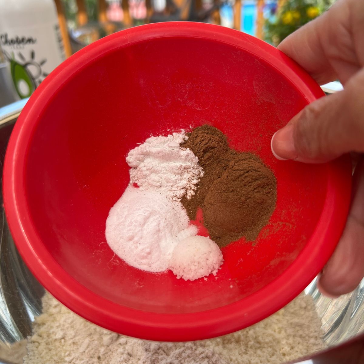 Dry ingredients in a red bowl for zucchini muffins