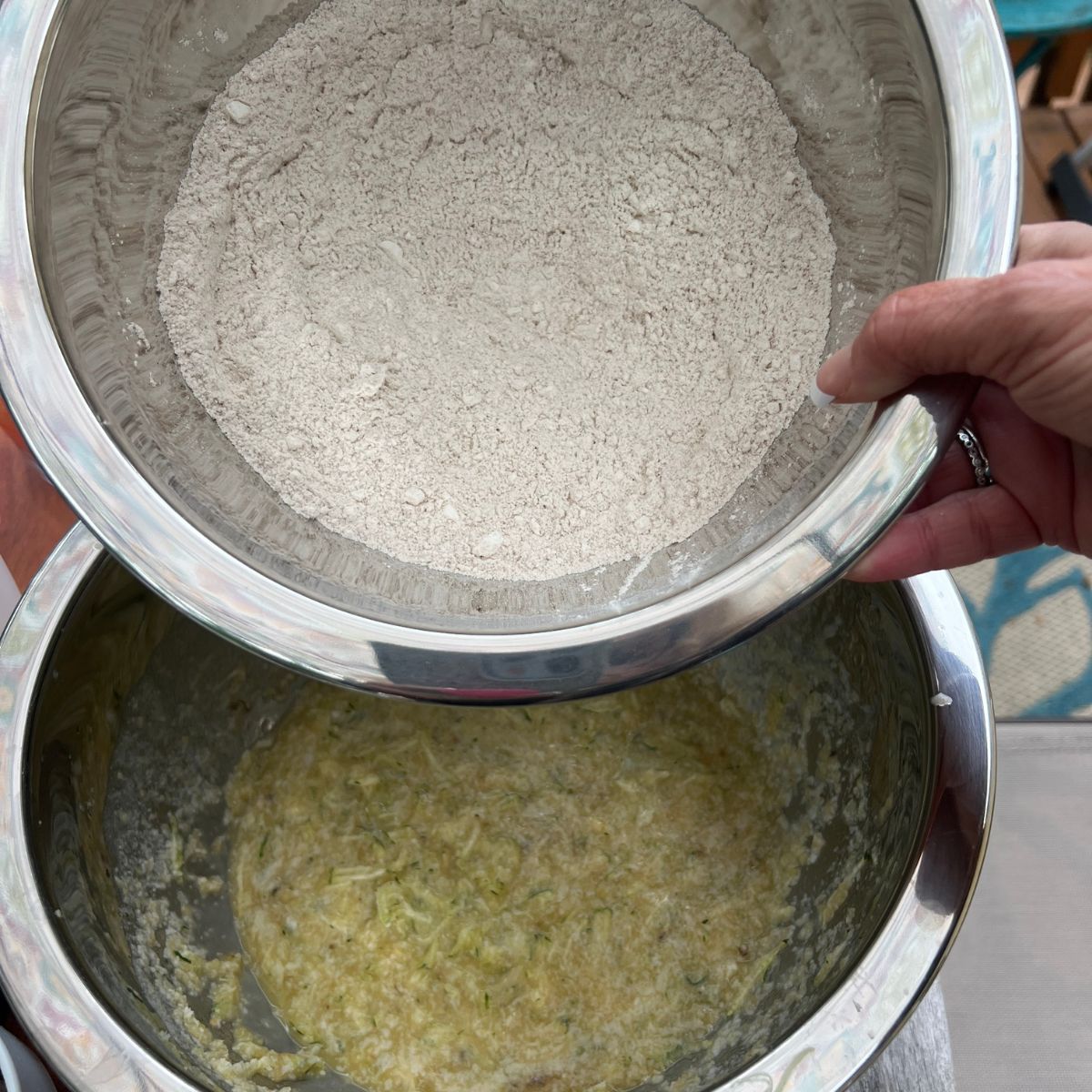 Dry and wet ingredients in a bowl for chocolate chip banana zucchini muffins