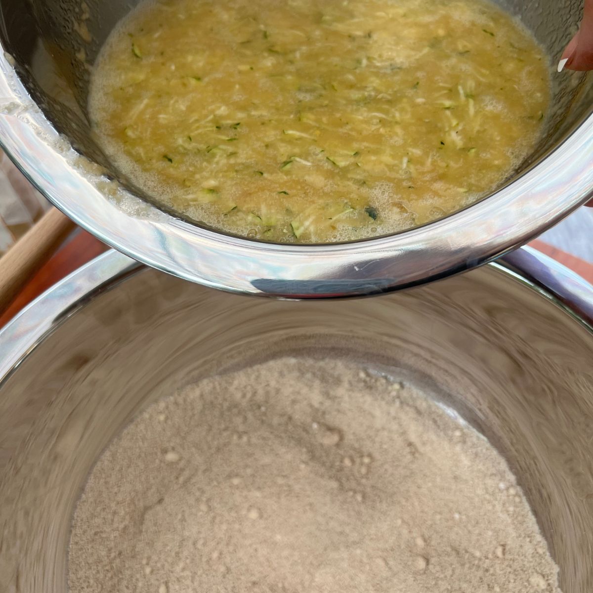 Wet and dry ingredients for healthy zucchini muffins being combined