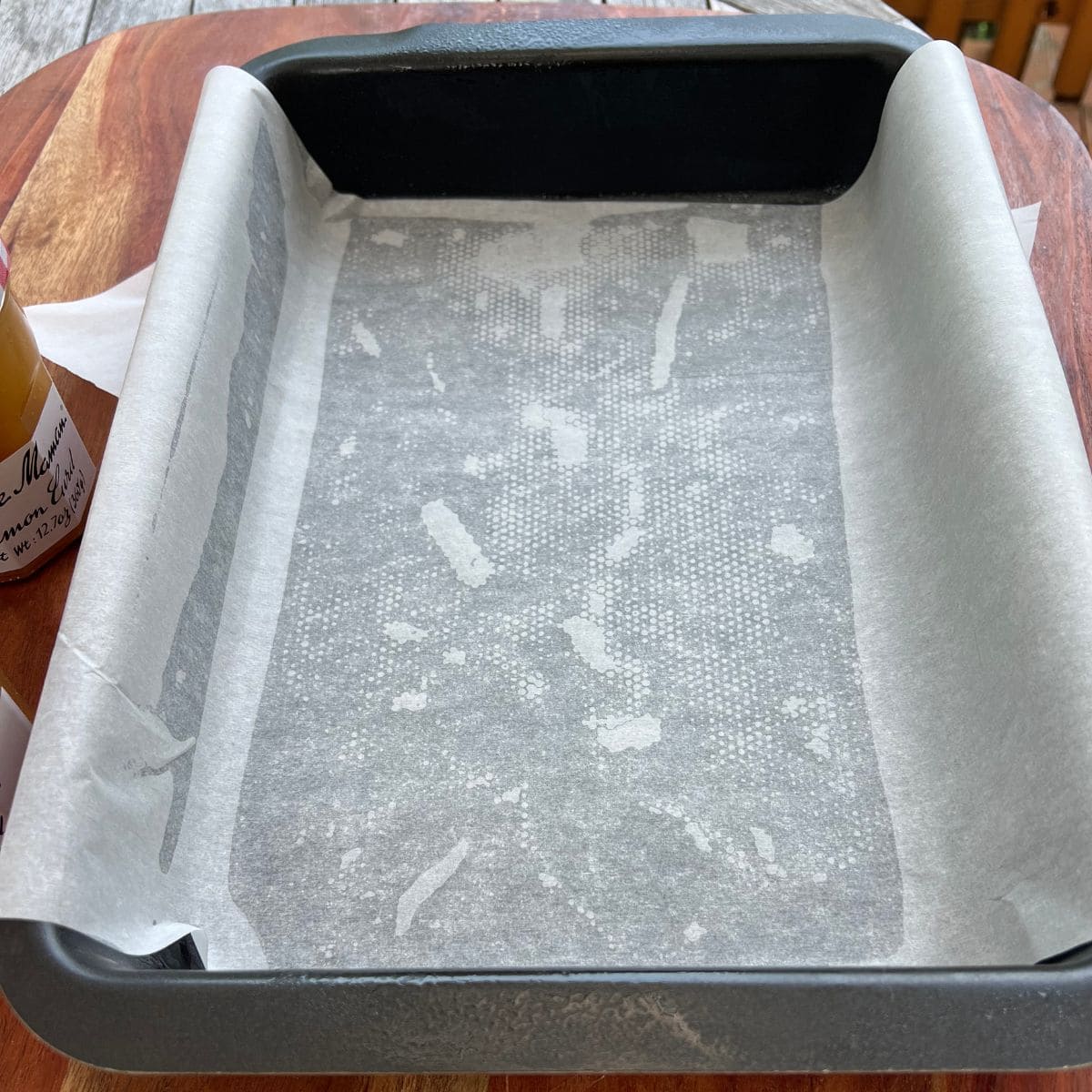 9x13 baking pan lined with parchment paper for baking a lemon curd dump cake