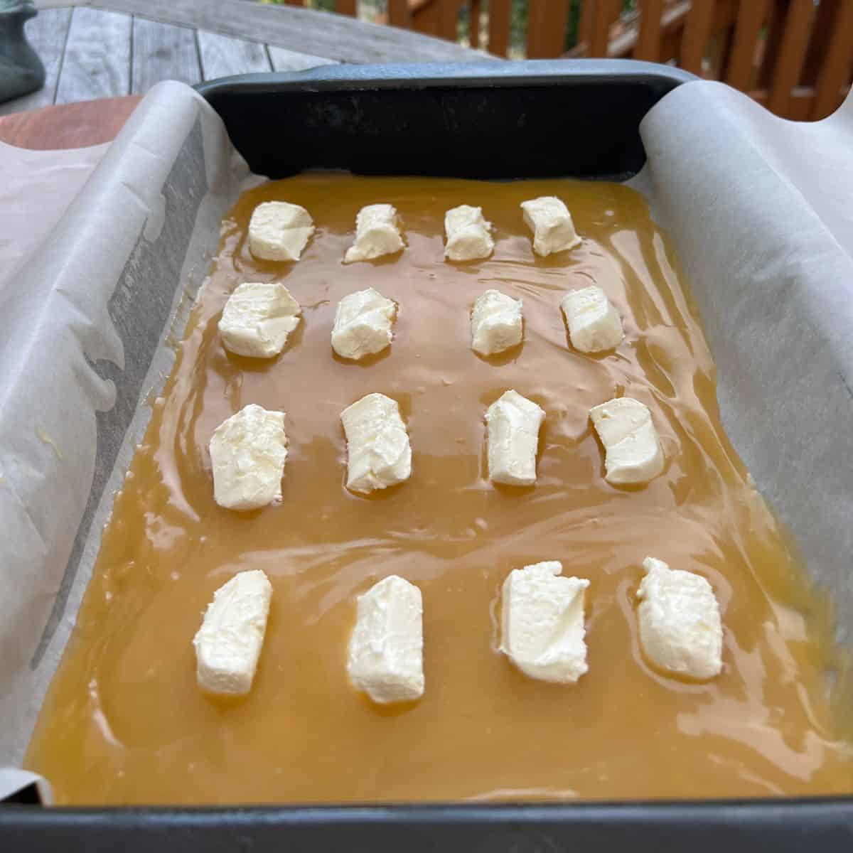 Lemon curd and Crean cheese square for lemon dump cake in a 9x13 inch baking pan