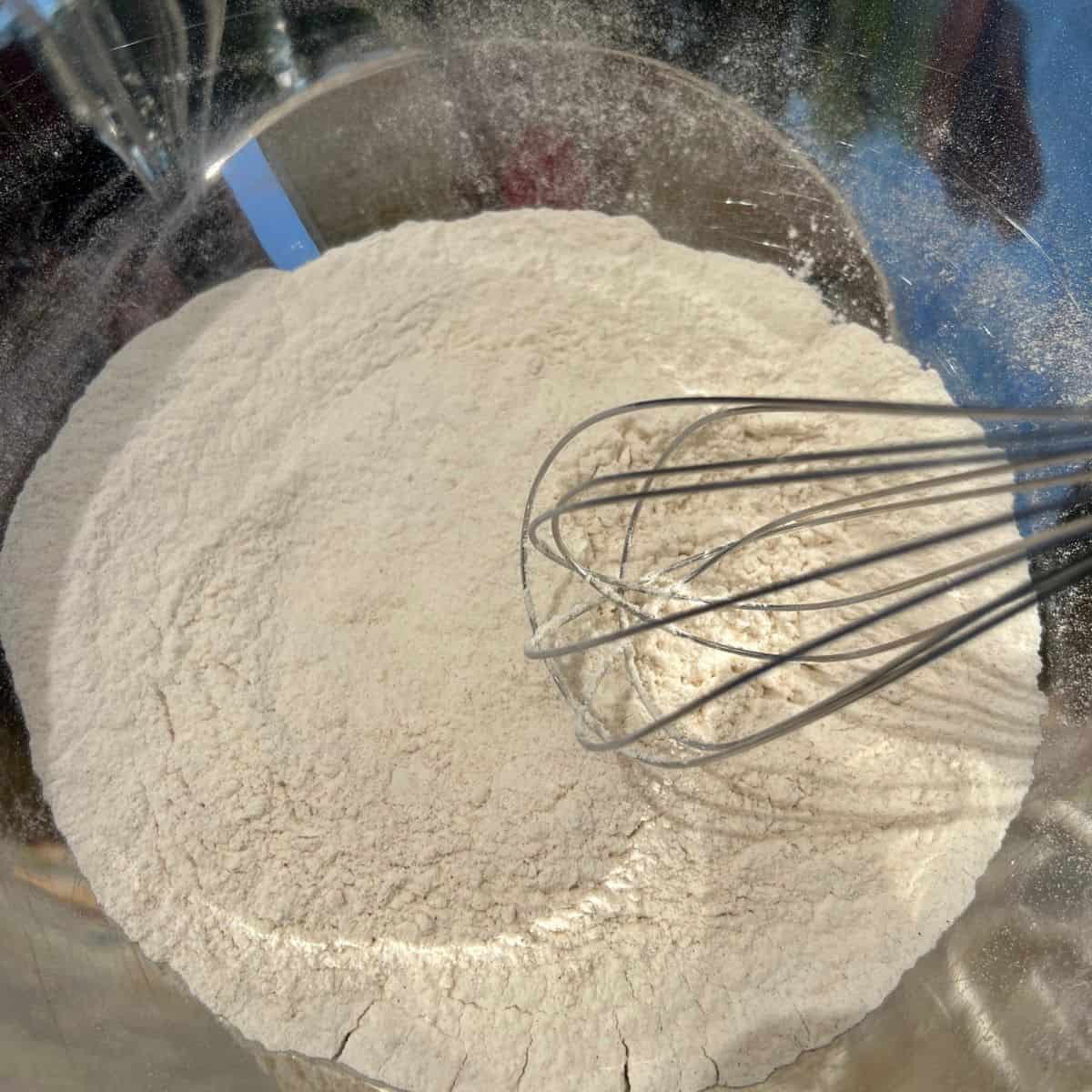 Whisking flour for peach muffins