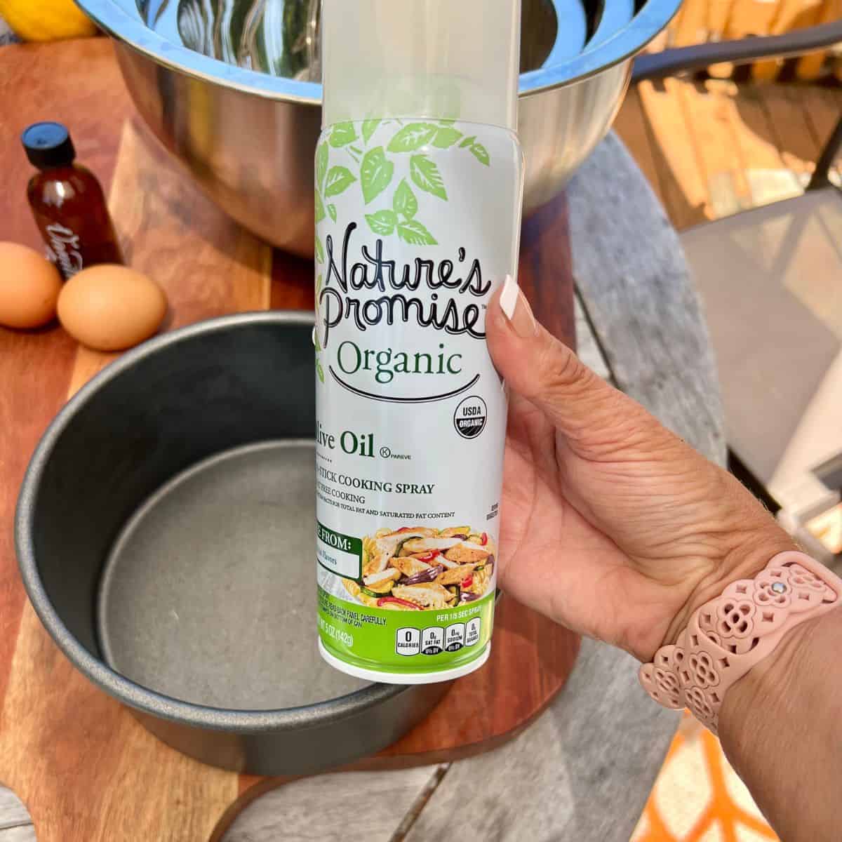 A can of spray olive oil and a 8 inch round baking pan for a moist lemon coconut cake recipe