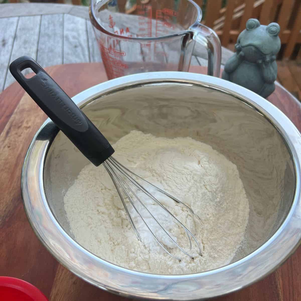 Whisking flour in a bowl for campfire smores chocolate chip cookies