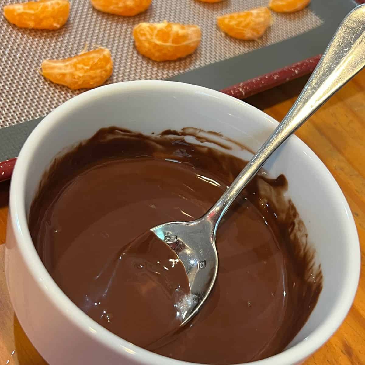 A bowl of melted chocolate for chocolate drizzled clementines