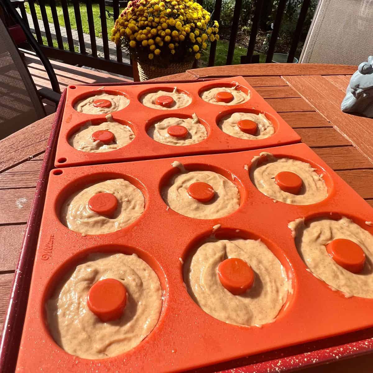 Apple cider donut batter in a silicone donut tray