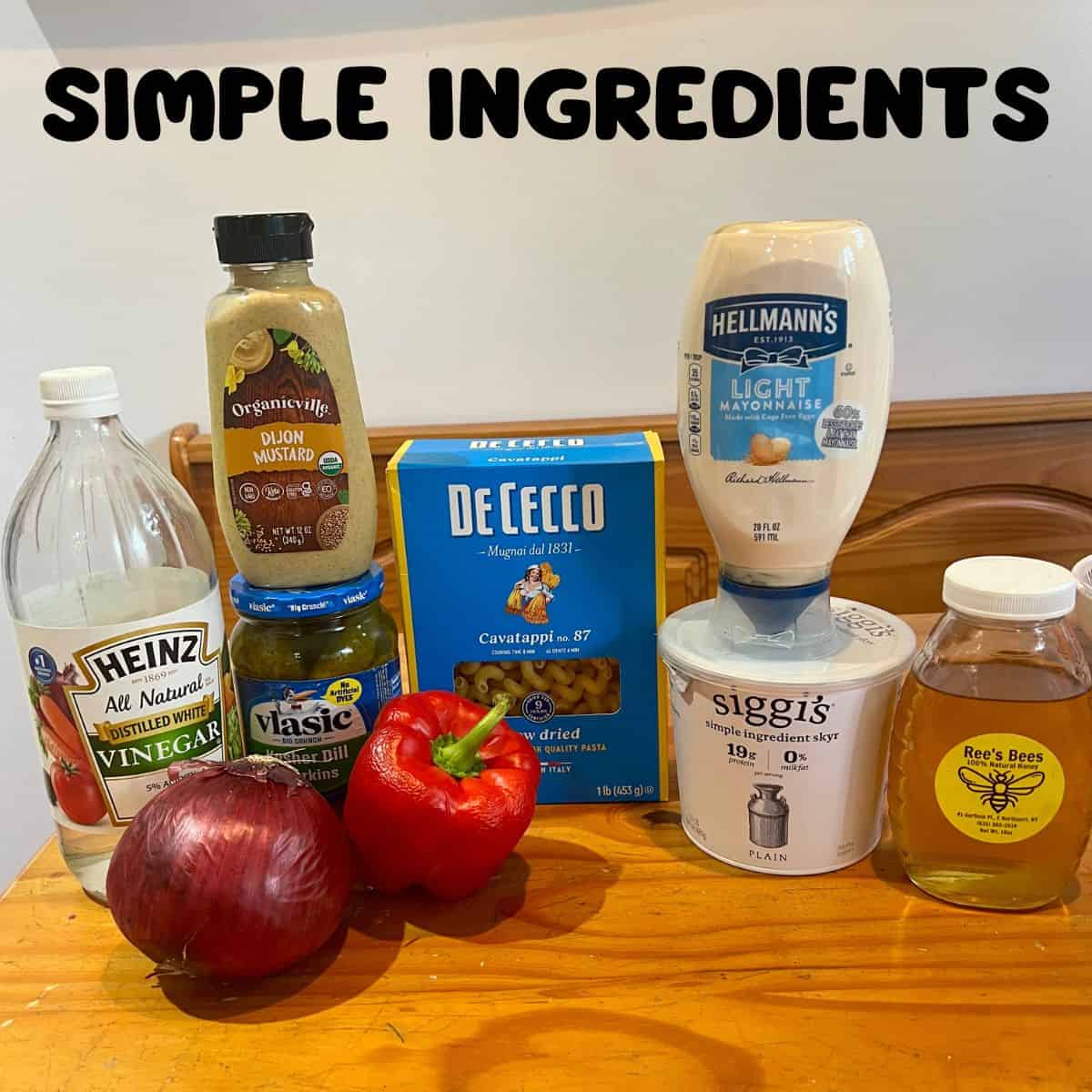 Pasta salad ingredients on a wooden kitchen table