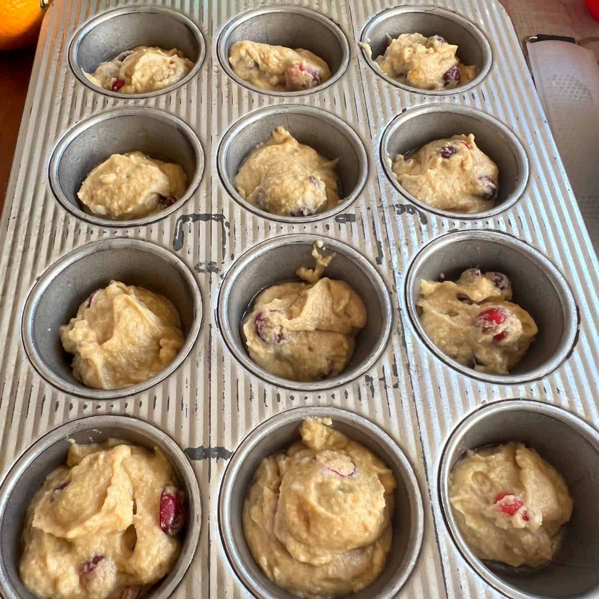 Cranberry Orange Muffin Batter in a muffin pan
