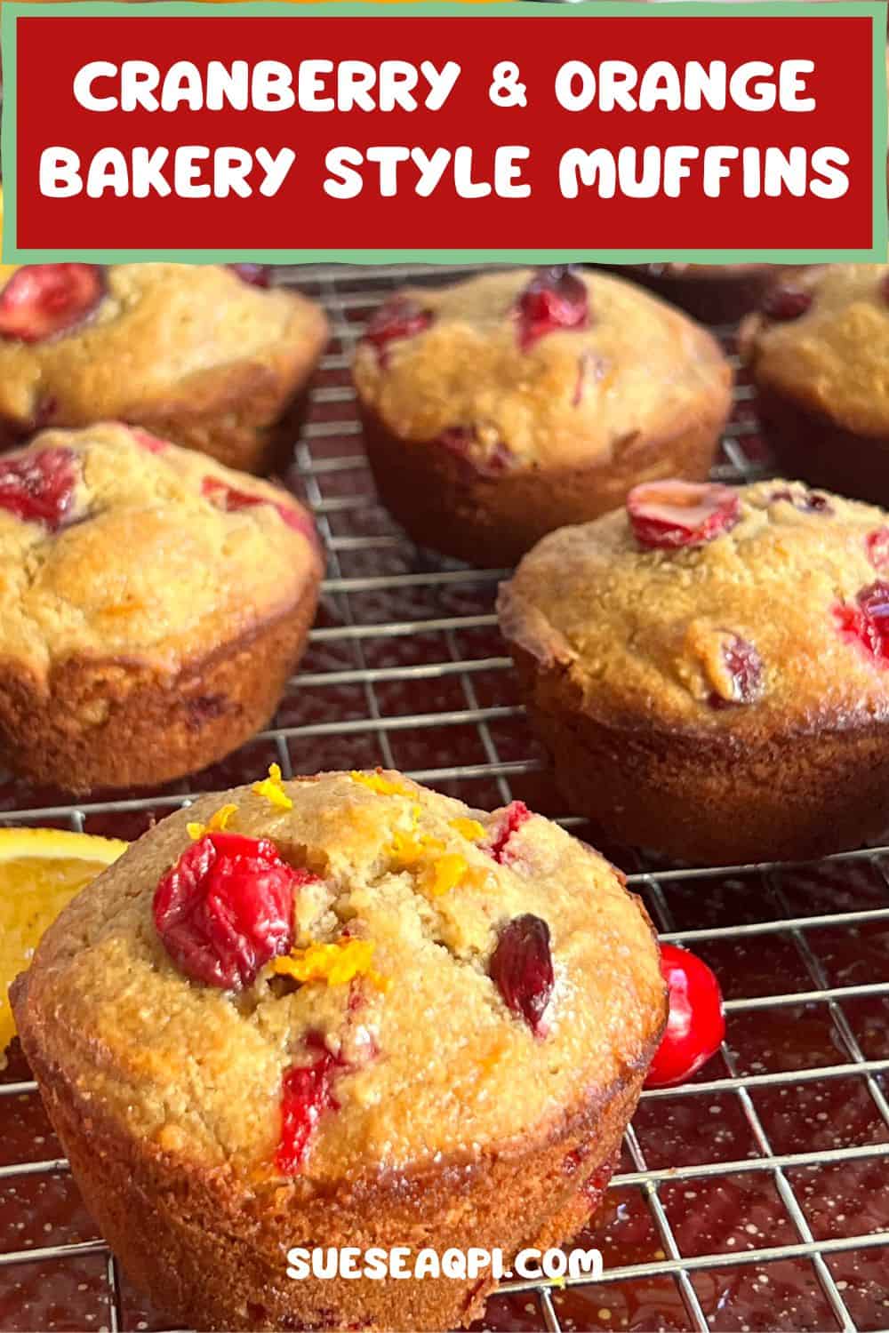 Healthy Cranberry and Orange Bakery Style Muffins on a wire rack