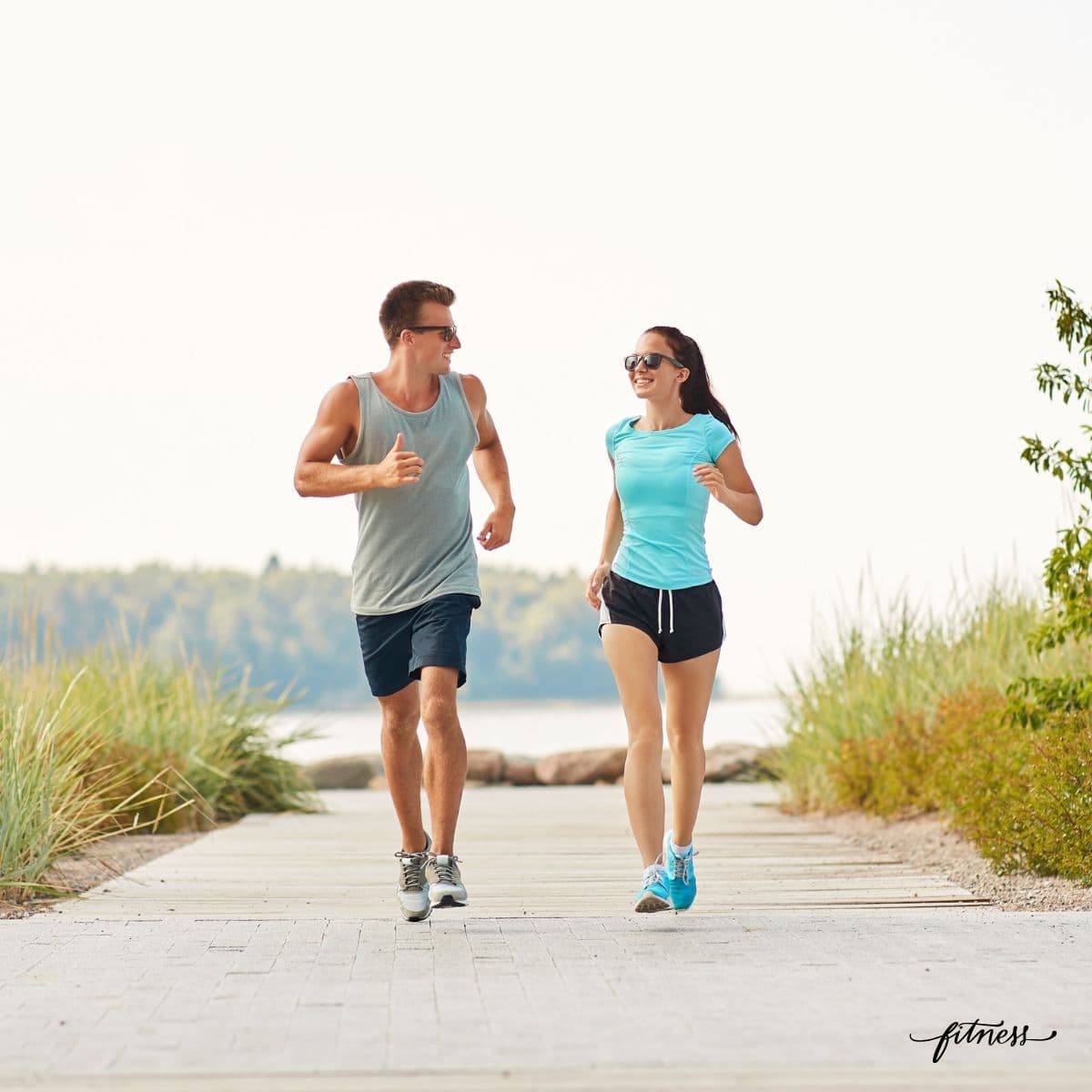A fit man and woman walking own a trail