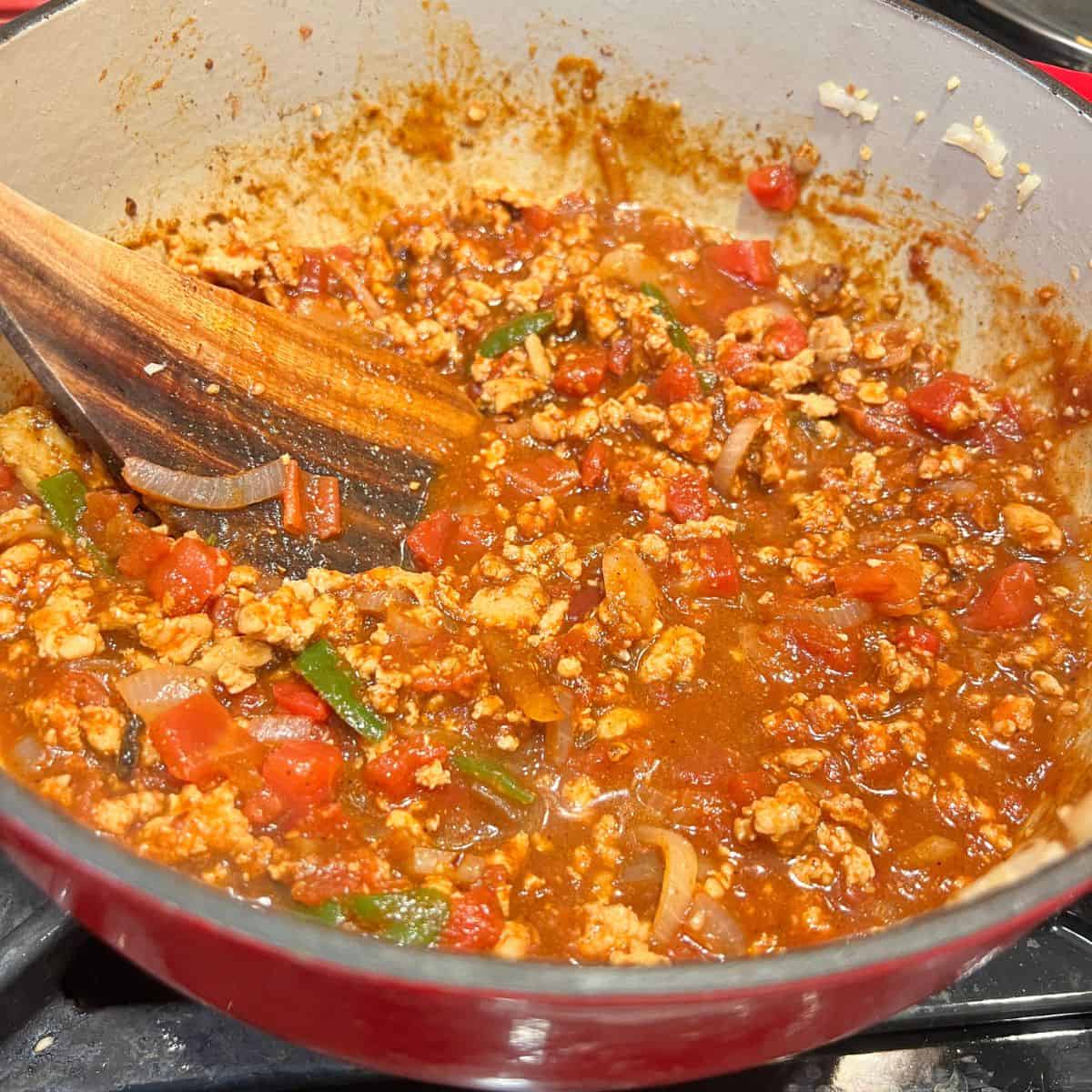 Healthy Tex-Mex Chicken Chili simmering in a Dutch Oven