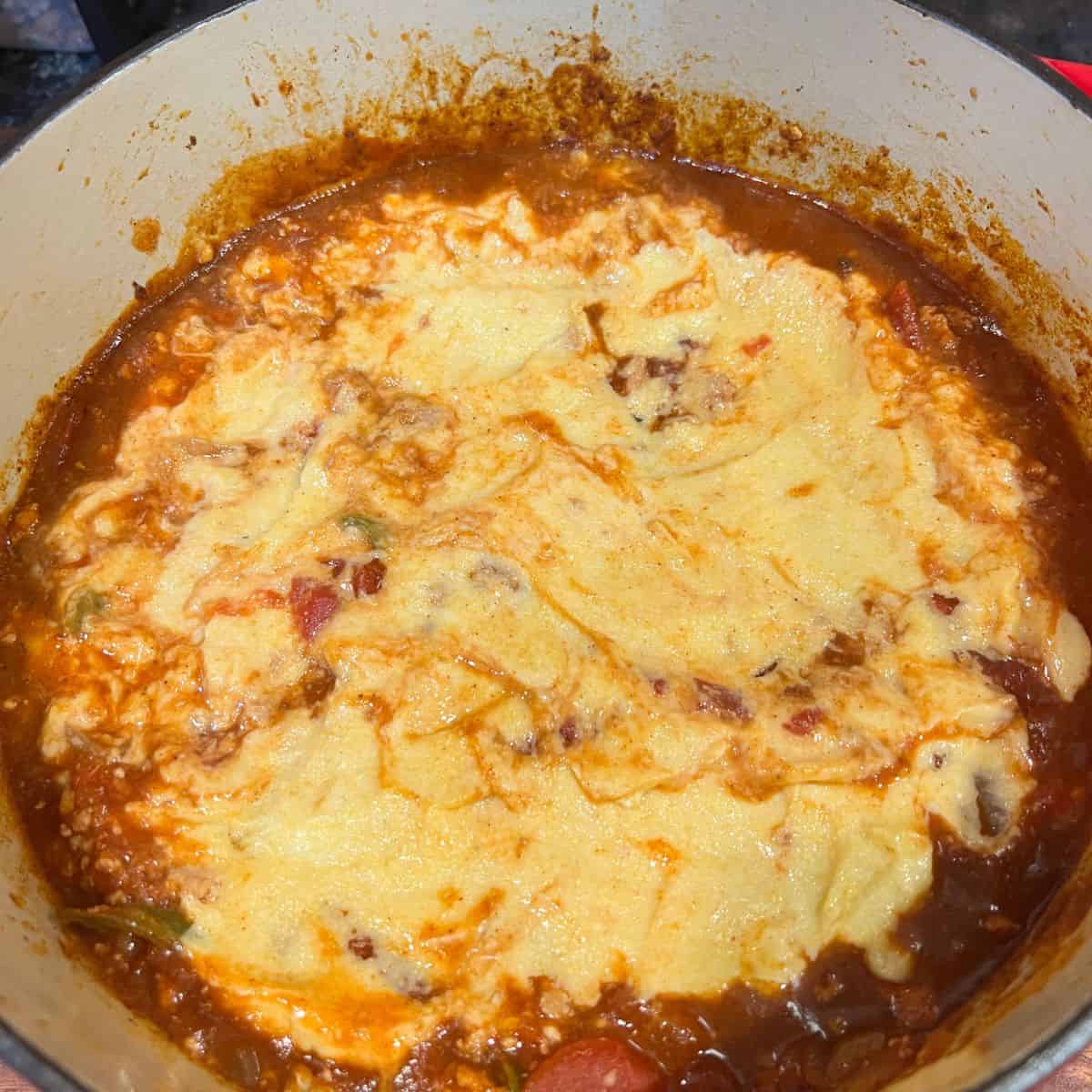 Tex-Mex chicken chili covered with Jiffy Muffin Batter in a pot