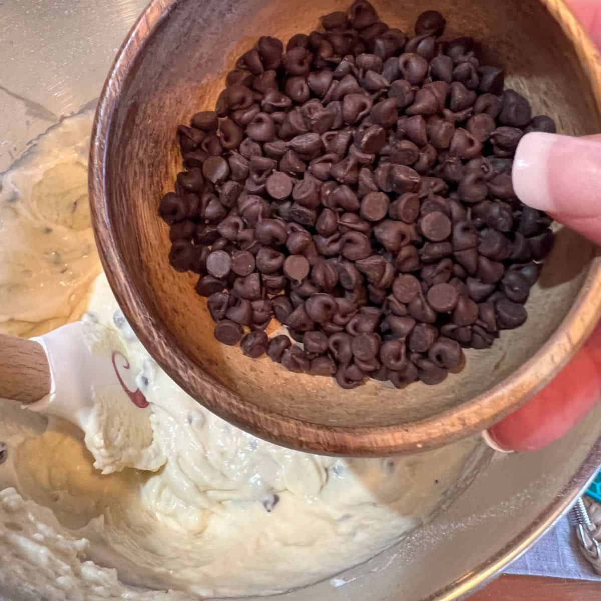 Adding chocolate chips to a bundt cake batter