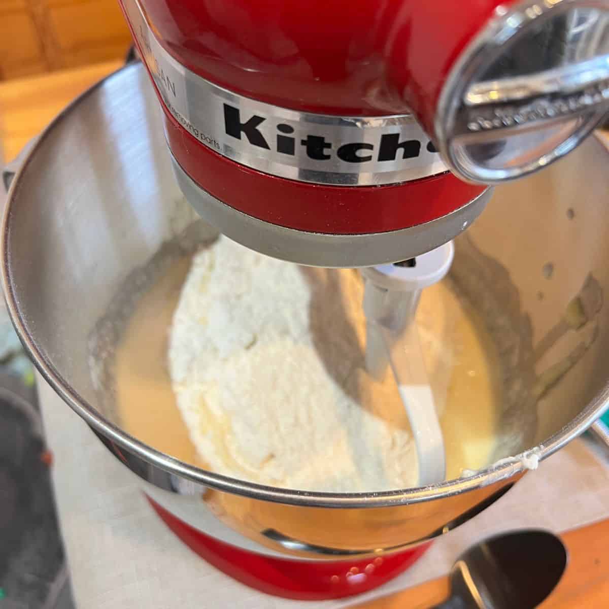 Creaming butter in a kitchen air mixer for a bundt cake recipe
