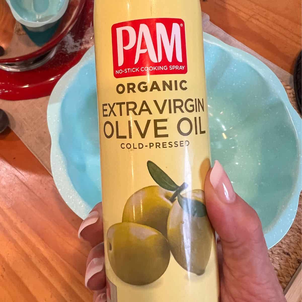 A can of spray olive oil with a bundt cake pan